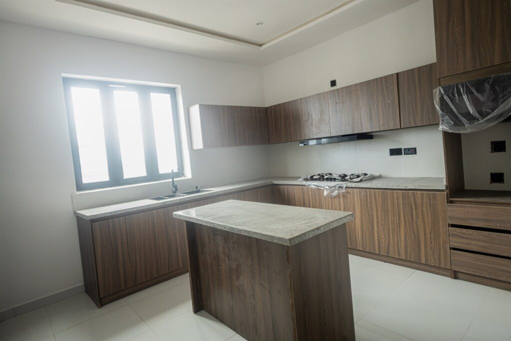 Brum Height 5: Fitted kitchen with wood-tone cabinets and a central island